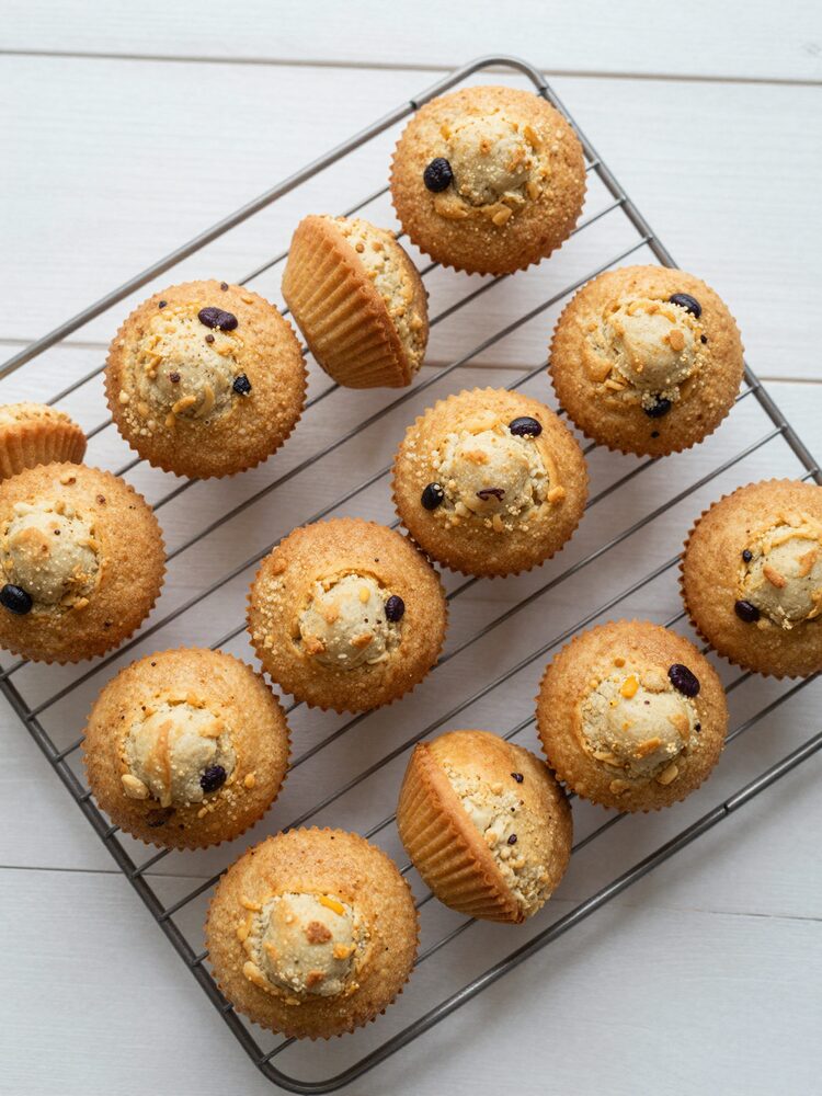 Batch of golden protein muffins cooling on a wire rack